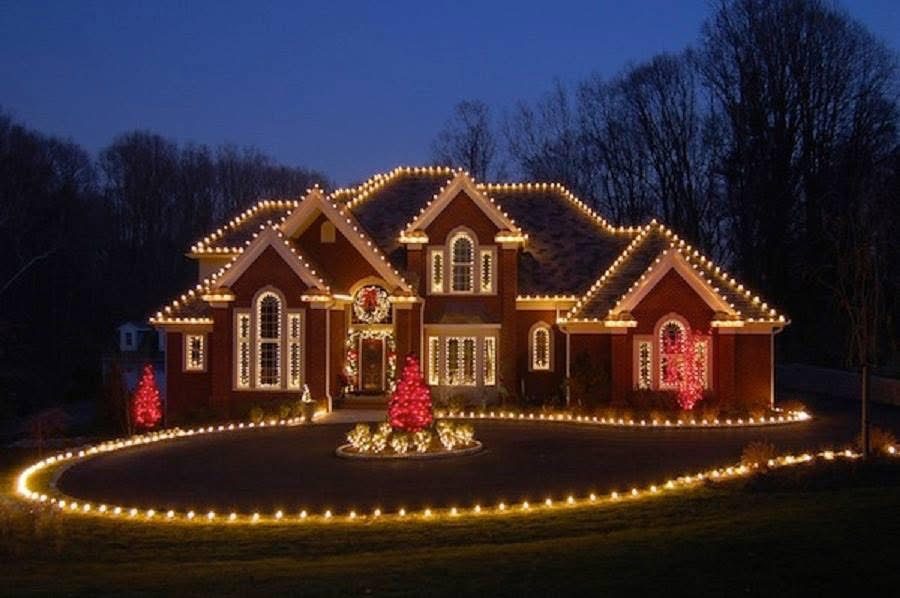 Finished Christmas light installation by Central AL Lighting on a brick home with a lit circular driveway